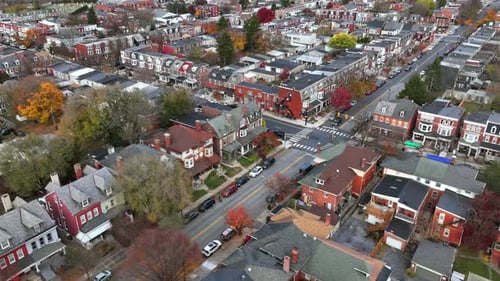 Aerial top down of junction in small american town with housing area. Driving Vehicle on road. Roof