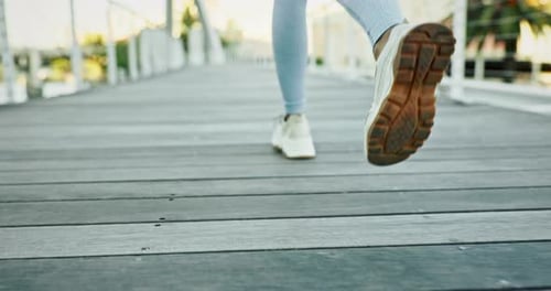 Legs Jogging on City Bridge