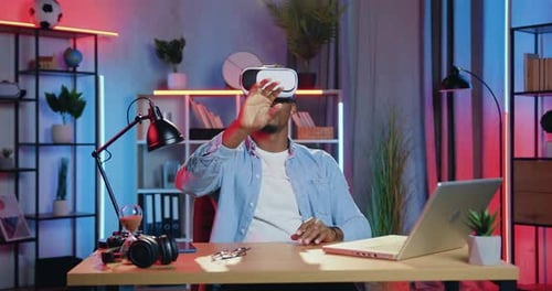 Man Uses Virtual Reality Headset in Office