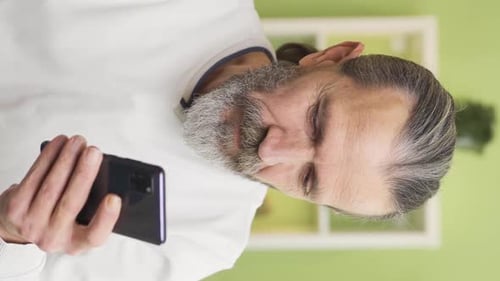 Man Using Smartphone Indoors
