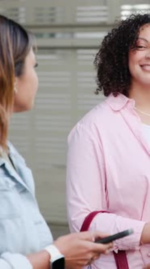 Vertical video: Pink shirt woman flipping curls outdoors, phone buzzing, other checking phone
