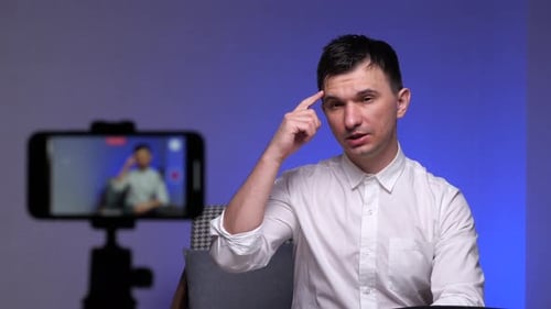 Man Filming Video Blog with Smartphone