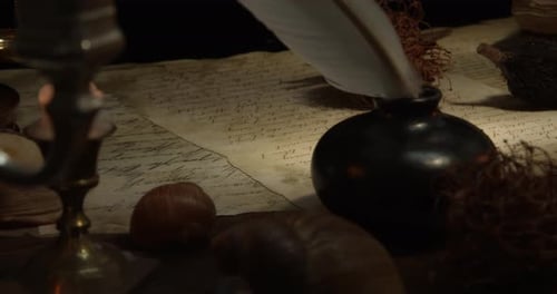 Quill, Inkwell, and Candle on Antique Writing Table