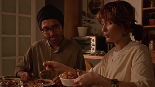 Man and Woman Eating Dinner Together at Home