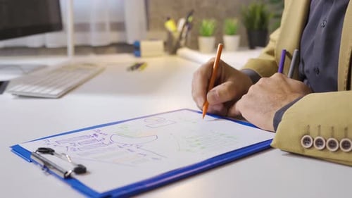 Man Reviews Financial Charts and Graphs