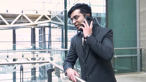 Smiling Man in Suit Talking on Cell Phone