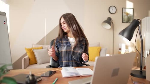 Young Woman Dancing at Desk