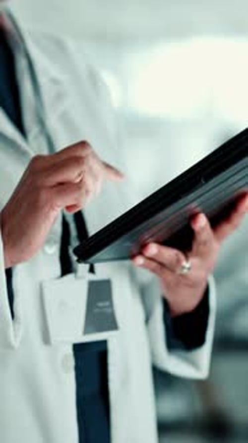 Doctor Using Tablet in Hospital Setting