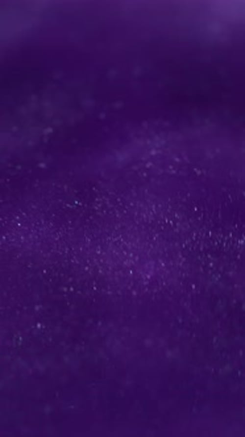 Abstract Purple Background with Glitter Particles Bokeh Effect