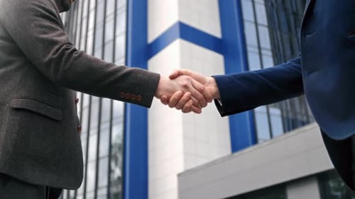 Two Fashion Business Man in Suit Shaking Hands Making Success Deal at Downtown Street Office Closeup
