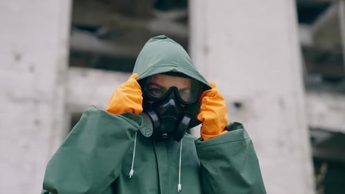 Human in mask and hazmat. Close up of woman in protective mask. Apocalypsis city.