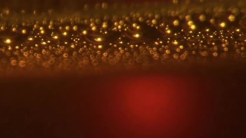 Alcohol Liquid Bubbles Texture Closeup. Golden Cold Craft Beer Frothing Effervescing Surface