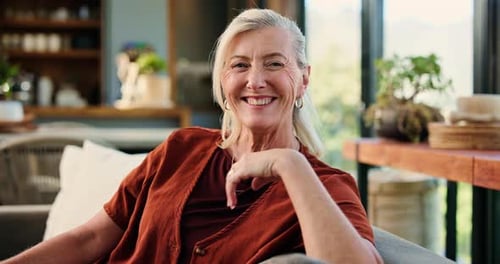 Happy, face and woman in lounge, relax and comfortable on couch, chill and laughing on break