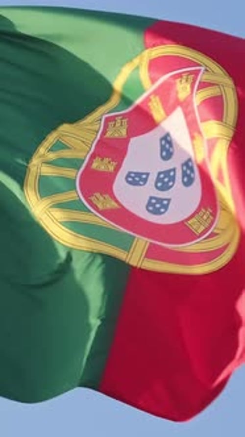 Closeup of National Flag of Portugal Waving in the Wind on Clear Sunny Day at Blue Sky Real Footage