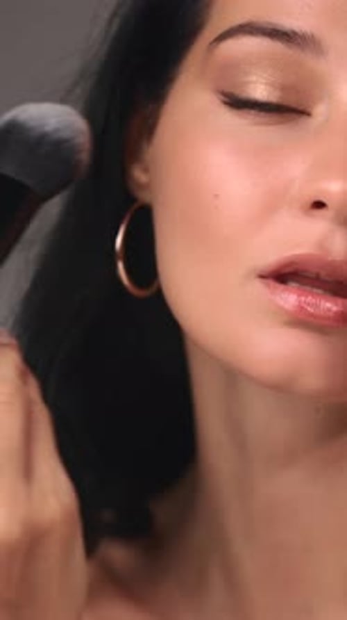 Woman Applies Powder Makeup with Brush, Close Up