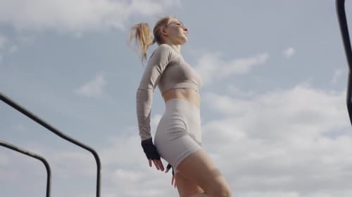 Active Woman Performing High Jump at Outdoor Fitness Park