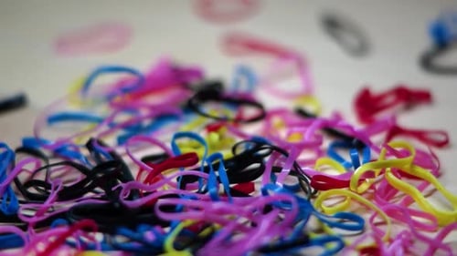 close up colorful rubber bands falling off