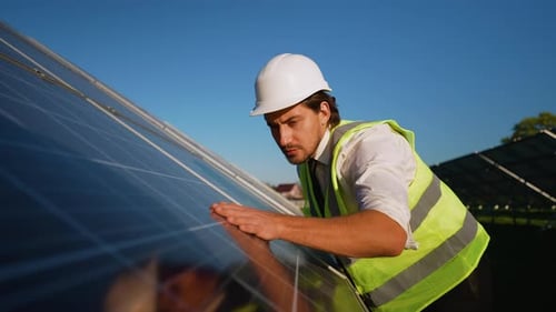 Engineer Conducts Detailed Solar Panel Inspection