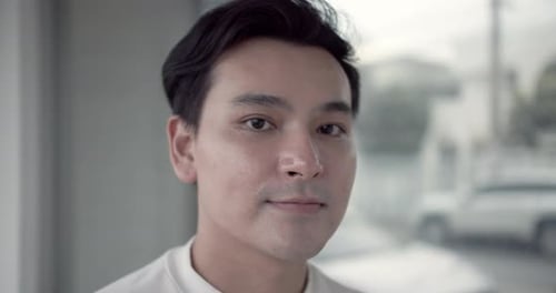 Young Man Adjusts Hair, Close Up Indoor Shot