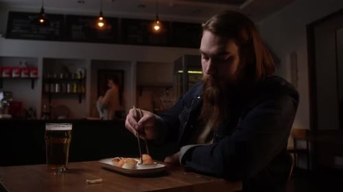 A Man Eating Sushi In A Cafe