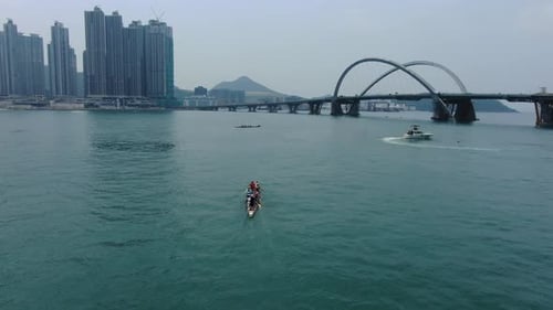 Dragon Boat team rowing to the pace of an onboard Drummer, Aerial view.