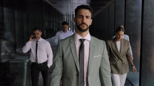 Serious Business Man on Way to Office Hallway Crowded Coworkers Handsome Young Earnest Successful
