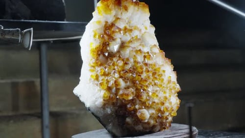 Artistic Display of Amber Crystal Under Spotlights