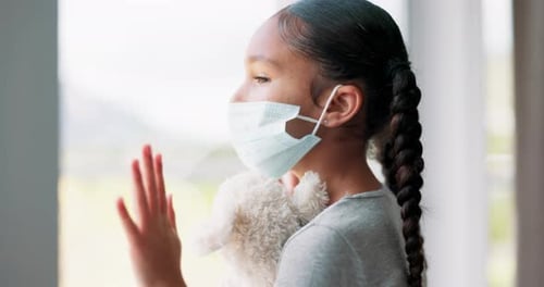 Sad Girl with Mask Looking out Window