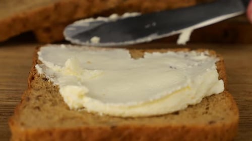 Butter Spreading on a Slice of Rye Bread