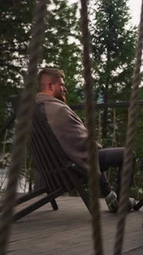 Young Couple Sits on Terrace at Ecohotel