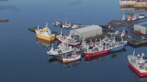 Aerial Islands Scenery with Traditional Fishing Boats Lying in Harbor on Sunny Day with Scenic Blue