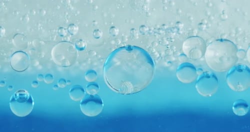 Slow motion macro of micro particles molecules in a liquid are analyzed with microscope for resear