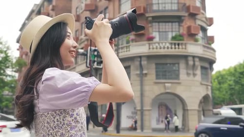 Woman Taking Pictures in Cityscape