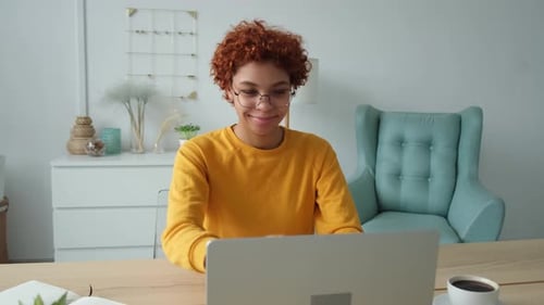 African Girl Closing Laptop Taking Break From Work on Computer at Home Office Young Woman Happy
