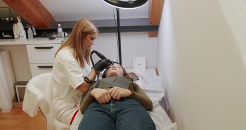 Beautician Treating Eyebrows in Beauty Salon