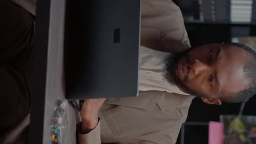 Frustrated Man Working on Laptop in Office