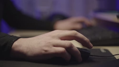 Hands Typing on Keyboard at Desk