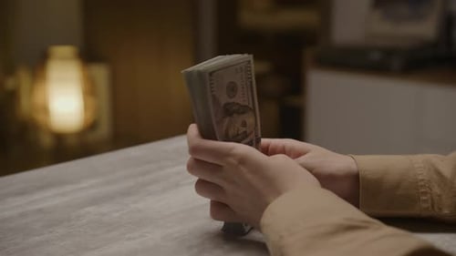 Hands Holding Thick Stack of Cash