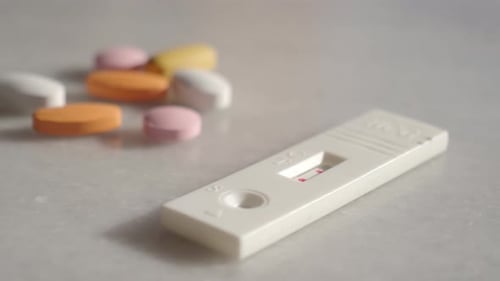 Pregnancy Kit and Medicine on a Table