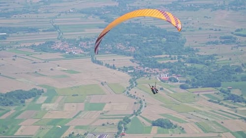Paragliding Adventure Over a Stunning Green Valley