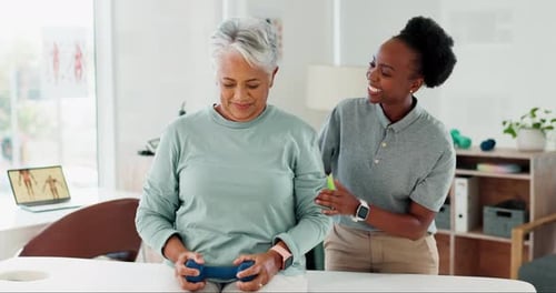 Senior Woman Lifts Dumbbell with Therapist's Support