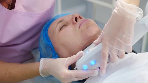Woman receiving cosmetic treatment in a clinic