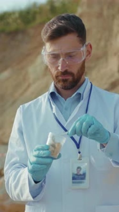 A Diligent Scientist is Meticulously Analyzing Various Samples Collected in the Field