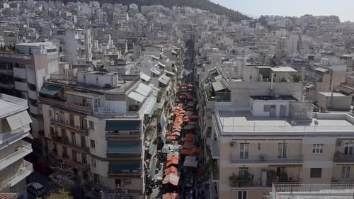 Aerial drone shot along street market Athens Greece panning down