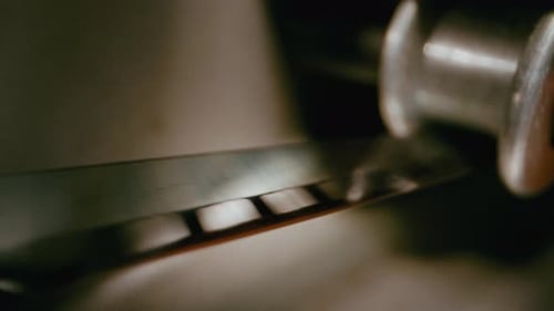 Film Strip Rolling Through Metal Mechanism