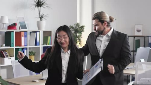 Multiracial Colleagues Dancing in Office