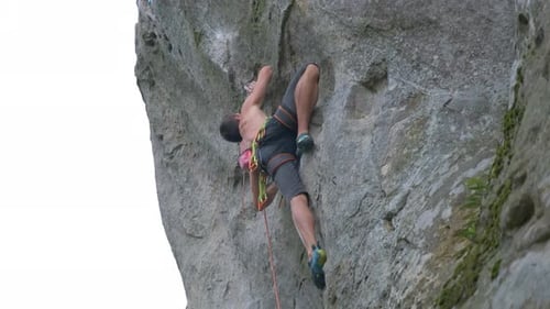 Young Man Climbing Steep Wall of Rocky Mountain Male Climber Overcomes Challenging Route Engaging in
