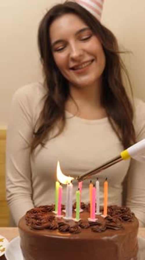 Joyful Woman Lights Candles on Birthday Cake