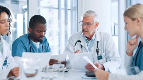 Medical Team Meeting Reviewing Documents