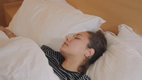 Serene Hotel Wakefulness Relaxed Woman Resting in Cozy Hotel Setting Tranquil Hotel Environment